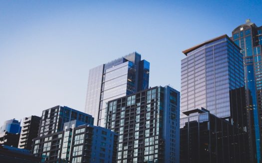 white and blue glass walled high rise building